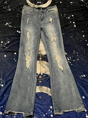 High-Rise Distressed Flare Jeans in Washed Denim